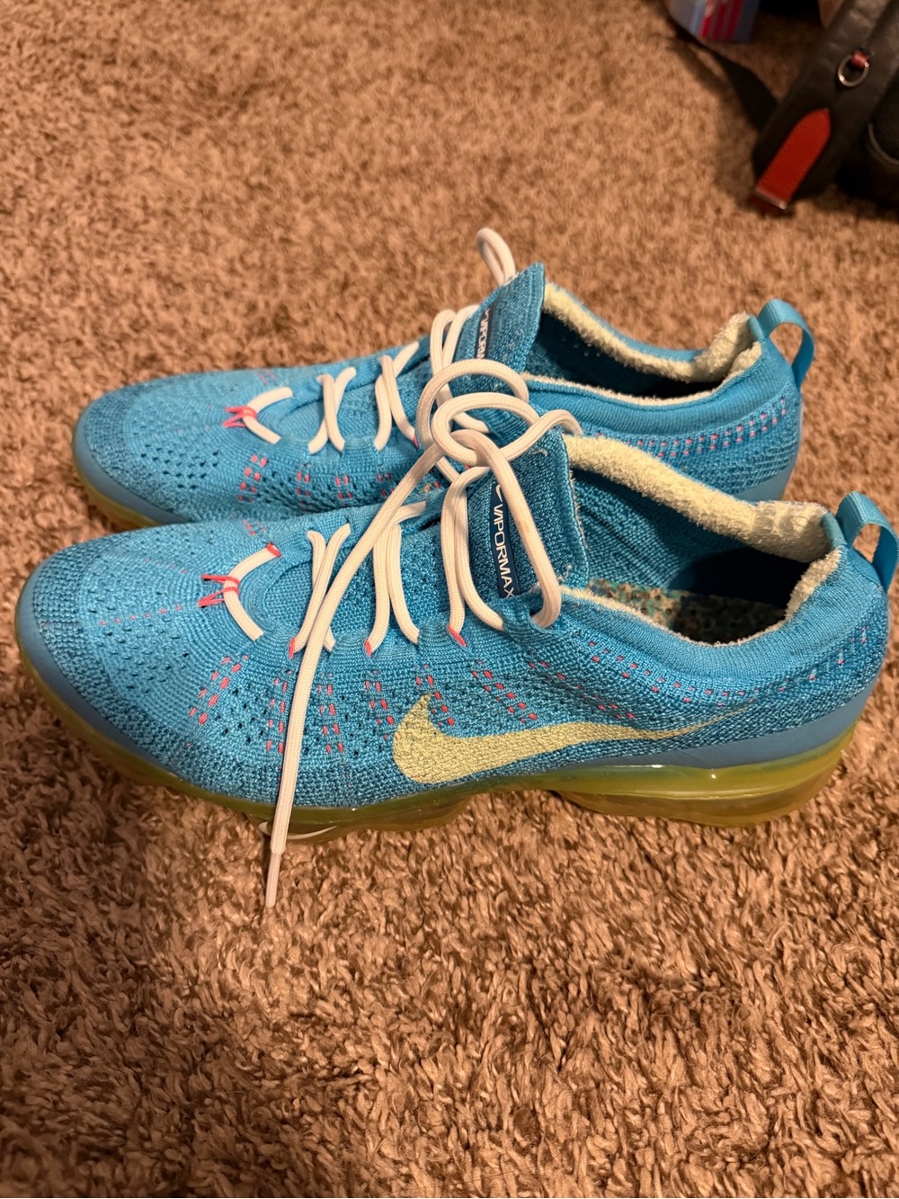 Nike Blue Flyknit Sneakers with Yellow Swoosh